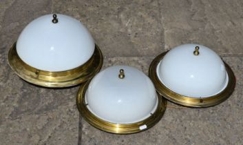 A pair of circular brass ceiling lights