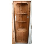A stained pine floor standing corner unit