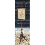 A Victorian carved mahogany pole screen
