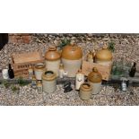 A collection of vintage stoneware flagons, jars glass bottles