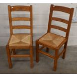 A set of four French oak ladderback dining chairs with rush-work seats