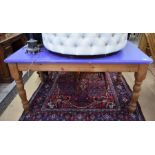 A rectangular pine kitchen dining table with blue painted top