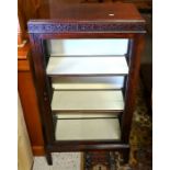 A glazed hardwood display cabinet on short square legs