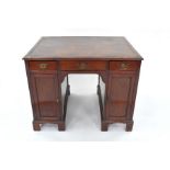 A George III mahogany kneehole writing desk