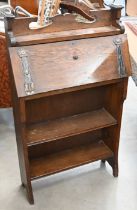 An early 20th century Arts & Crafts oak and metal mounted shallow bureau