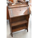 An early 20th century Arts & Crafts oak and metal mounted shallow bureau