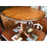 An elm veneer extending dining table, with integral folding leaf