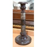 A turned serpentine marble candlestick