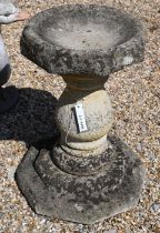 A reconstituted weathered stone pedestal birdbath, 62 cm high