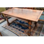A reproduction oak refectory dining table and six chairs