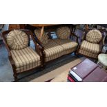An Edwardian carved mahogany framed bergere suite
