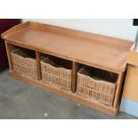 Teak hall bench storing three wicker baskets