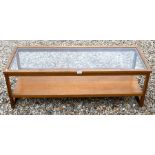 A teak glass top mid-century coffee table with under-tier