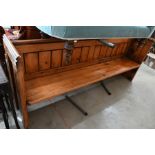 A stained pine pew