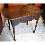 An antique oak side table with three drawers