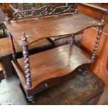A Victorian two-tier serpentine what-not with base drawer