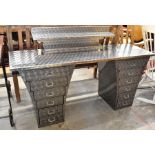 A modern brushed steel twin pedestal desk