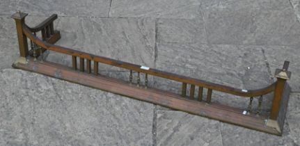 An early 20th century brass fender