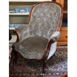 A Victorian carved mahogany armchair with oyster button back dralon upholstery
