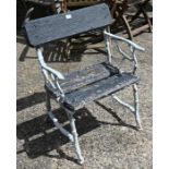 A naturalistic painted cast iron garden chair