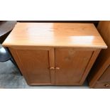 A light elm two door side cabinet with moulded handles