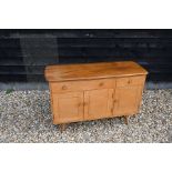 An Ercol Windsor elm and beech sideboard