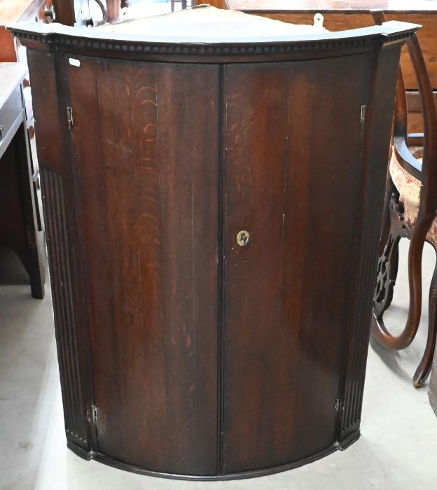 A 19th century oak hanging corner cupboard