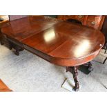 An antique mahogany draw leaf dining table with three leaves