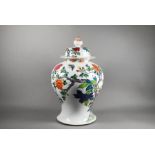 A 19th century Chinese famille rose baluster vase and cover painted with peonies, late Qing