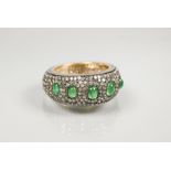 A South African diamond and emerald bombe eternity ring