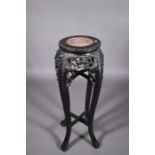 An antique Chinese carved and moulded hardwood stand