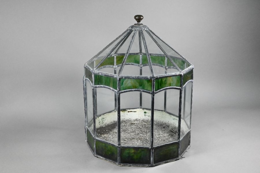 A vintage leaded glass terrarium with green marbled panels