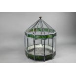A vintage leaded glass terrarium with green marbled panels