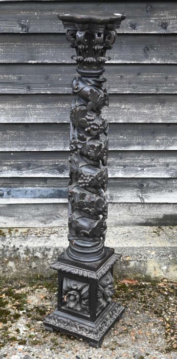 An antique carved solomonic style vine leaf design column