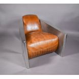 A bespoke polished alloy and tan leather 'Aviator' styled armchair