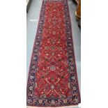 A Persian Sarouk runner, 307 cm x 84 cm