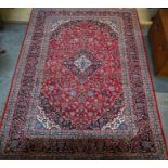 A Persian Kashan red ground carpet, 348 cm x 248 cm
