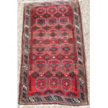 An old Belouch red/brown ground rug