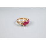 A three stone ruby and diamond ring