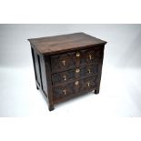 A 17th century and later joint oak chest of three long drawers