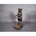 A 19th century Black Forest carved bear stick stand