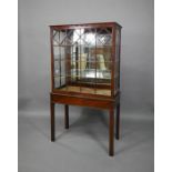 A Georgian Chippendale style glazed mahogany display cabinet on stand
