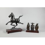 A Chinese replica of The flying Horse of Gansu to/w bronze Sanxing group with stands