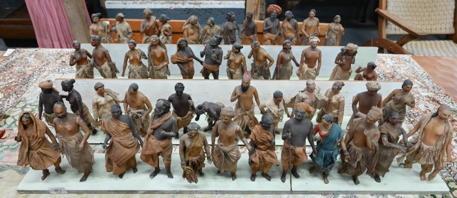 A collection of vintage Indian painted carved wood figures in a variety of traditional costume