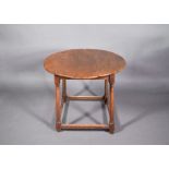 An antique circular elm-top table