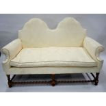 A traditional Queen Anne style double hump-back sofa