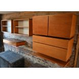 A quantity of Beaver & Tapley teak wall mounted modular furniture including drawers, open