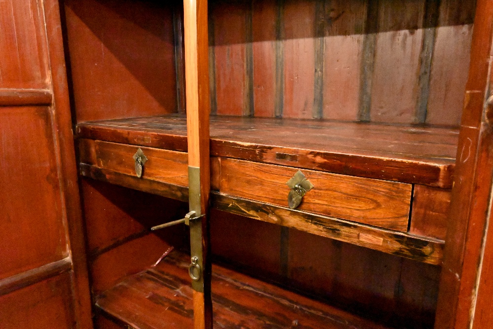 A Chinese hardwood and brass mounted two door cupboard, the interior fitted with shelves and two - Image 4 of 4