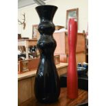 Large carved black glass baluster vase, 99 cm high to/w a slender red-glazed pottery vase, 87.5 cm