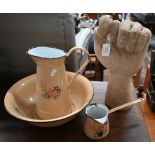 Cast stone 'clenched fist' 33 cm to/w a floral-printed enamel ewer and basin with matching pan (4)
